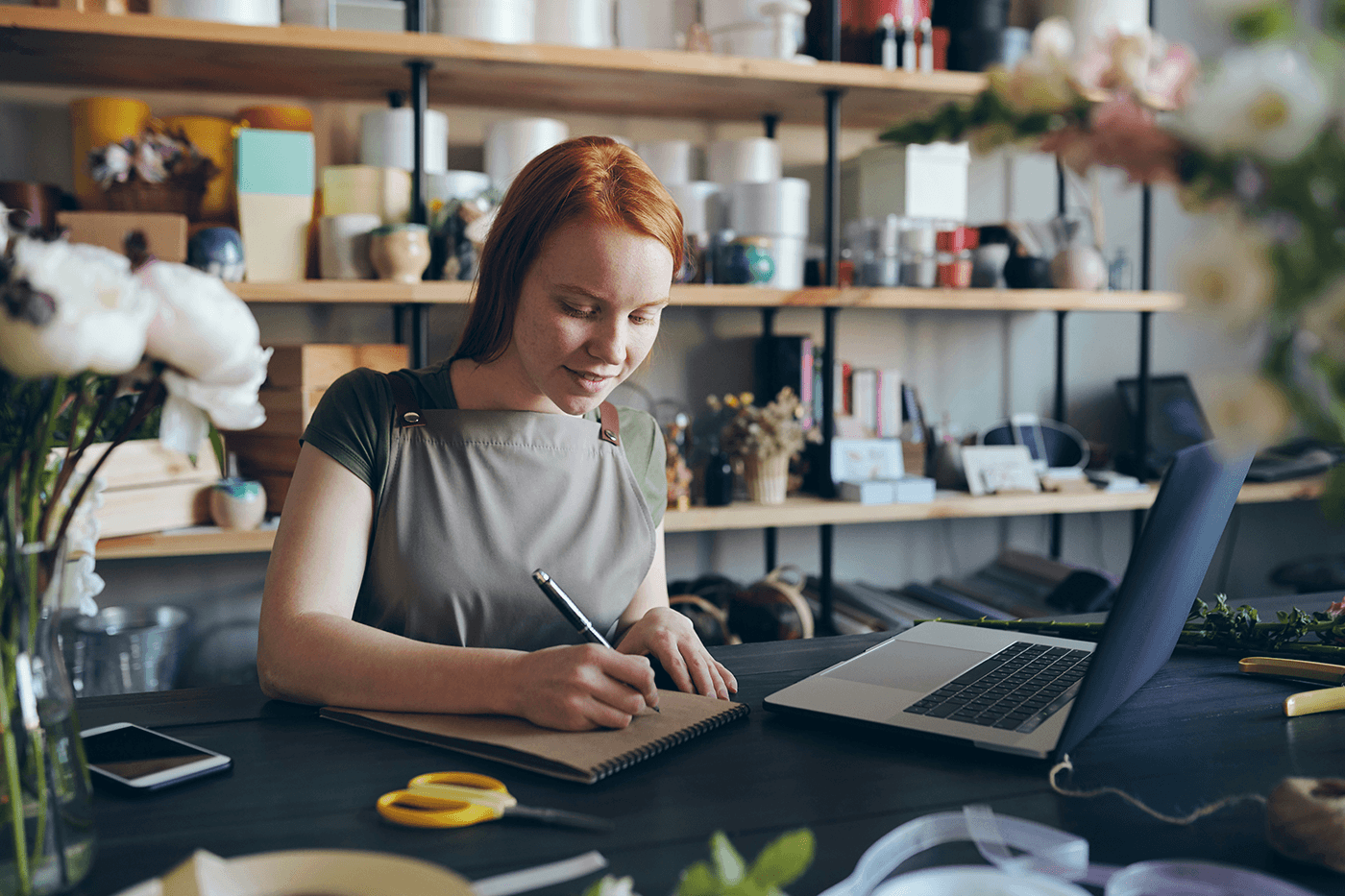 Website Privacy Policy: Woman smiling and sitting at a laptop