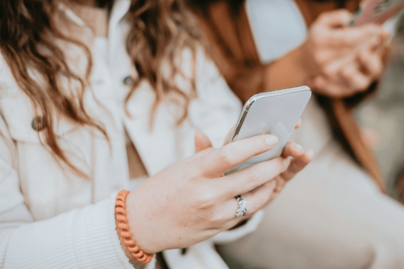 Woman on a phone doing a website checklist.